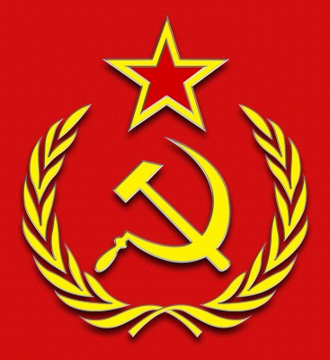 A red background featuring a gold circular emblem with a hammer and sickle, surrounded by a laurel wreath and topped with a five-pointed star.