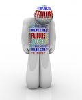 3D figure with words like 'failure', 'loser', and 'reject' covering its surface, conveying a theme of negative self-perception.