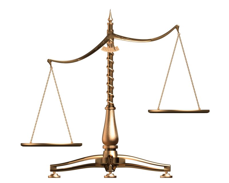 A bronze balance scale with two empty pans, symbolizing justice and equality.